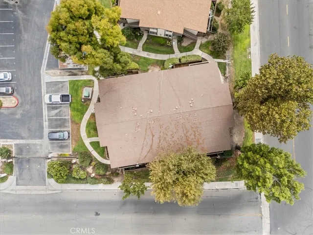 an aerial view of a house with a yard and lake view in back