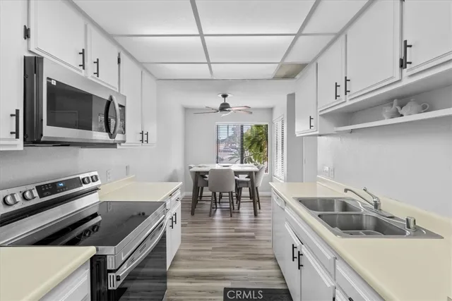 a kitchen with stainless steel appliances a refrigerator stove and microwave