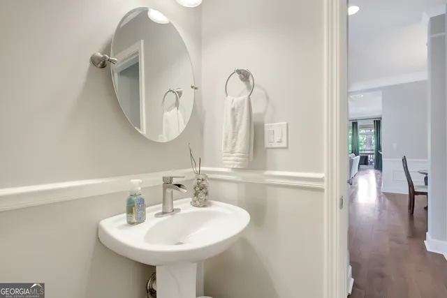 a view of a dining room with furniture a chandelier and wooden floor