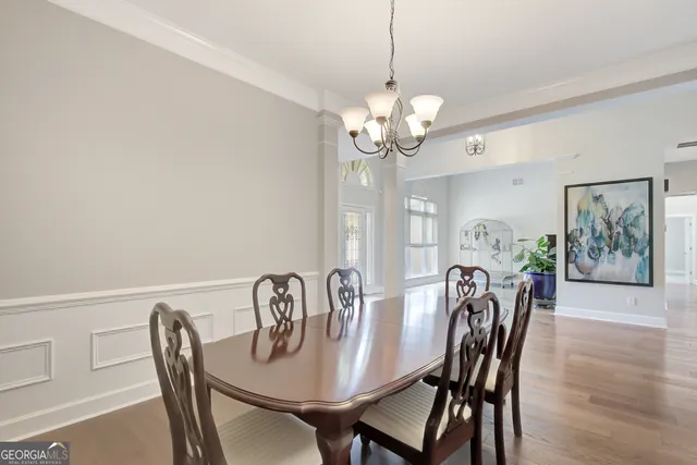 a view of a dining room with furniture and wooden floor