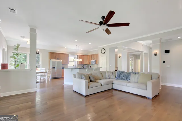 a living room with furniture a fireplace and a flat screen tv