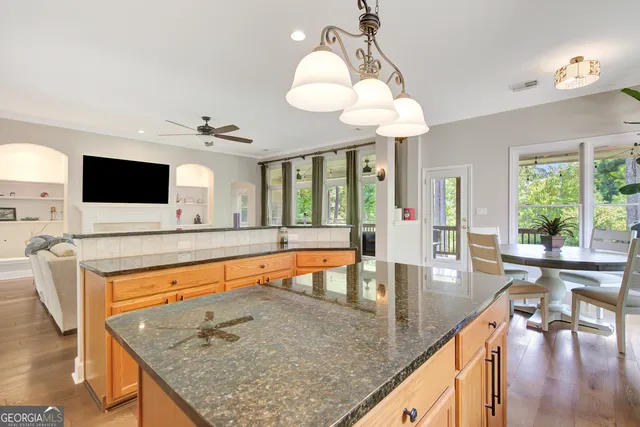 a dining room with furniture a chandelier and wooden floor