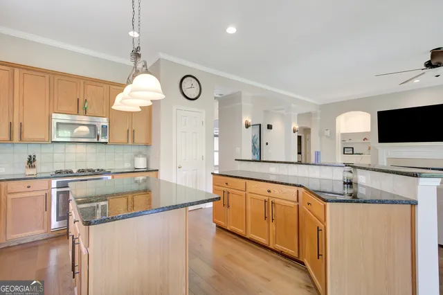 a dining room with furniture a potted plant and wooden floor
