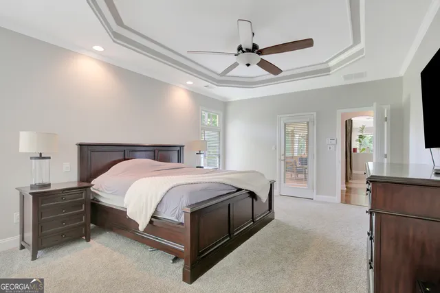 an empty room with windows and ceiling fan