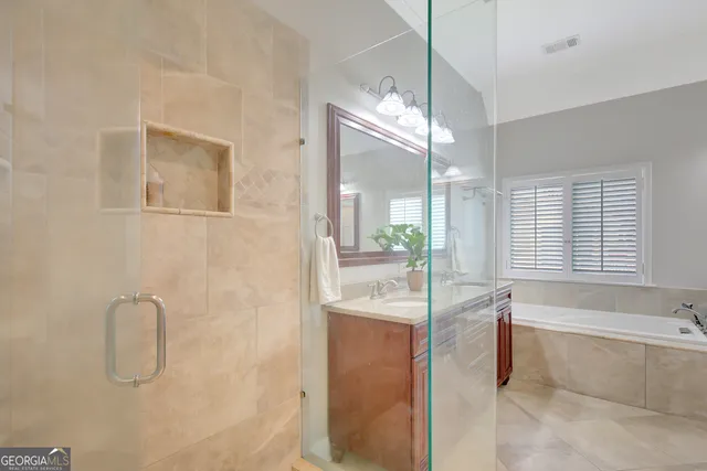a view of an empty room with a chandelier fan
