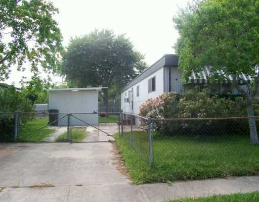 a view of a house with a yard and a patio