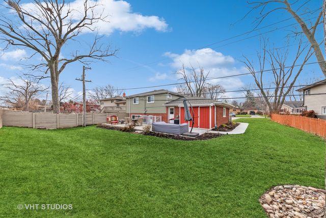a view of a house with a backyard