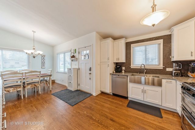 a kitchen with a sink cabinets and wooden floor