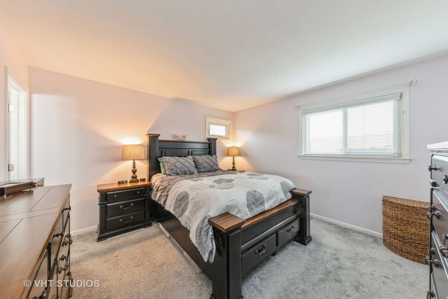 a bed room with a bed and window