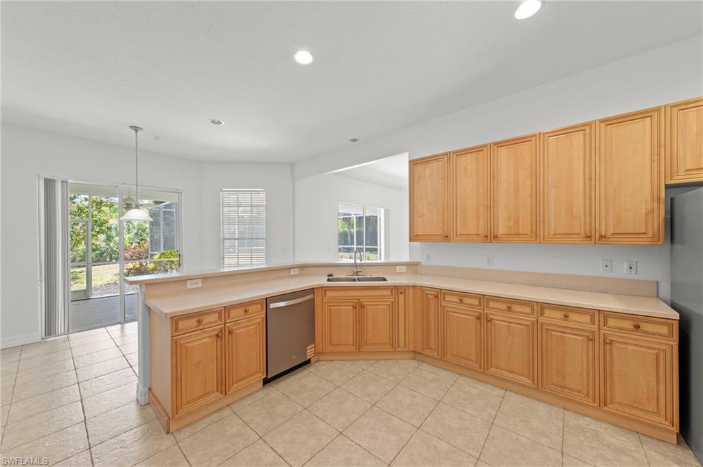 9623 Springlake Circle Estero, FL 33928 - Photo 17 of 47 a large white kitchen with a sink and cabinets