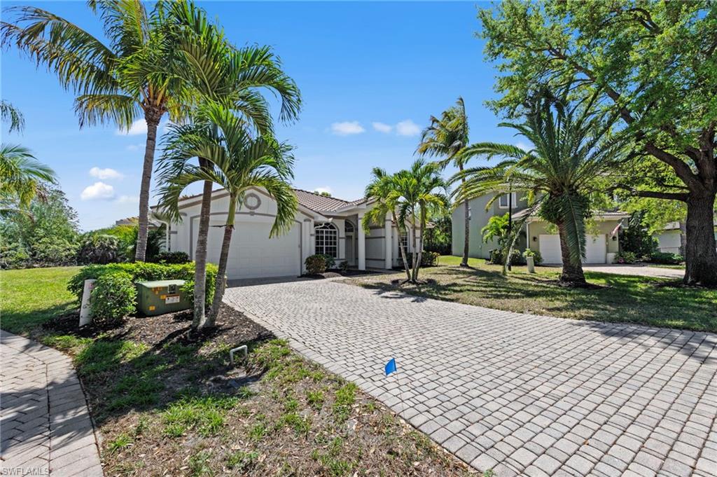 9623 Springlake Circle Estero, FL 33928 - Photo 2 of 47 a view of a house with a yard and coconut trees