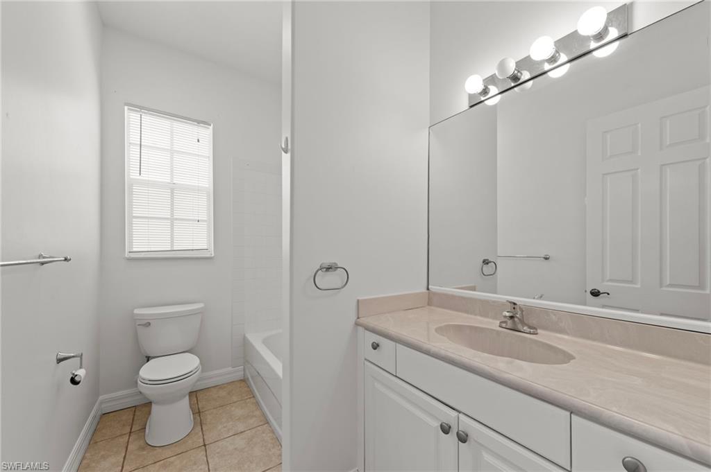 9623 Springlake Circle Estero, FL 33928 - Photo 28 of 47 a bathroom with a toilet a sink and mirror