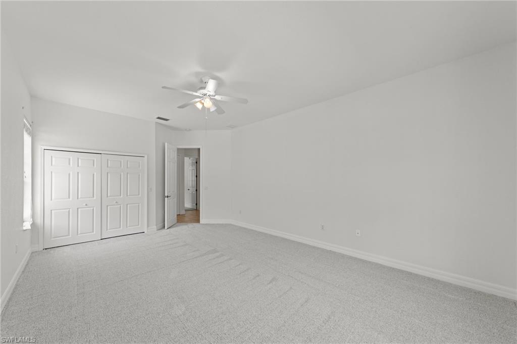 9623 Springlake Circle Estero, FL 33928 - Photo 29 of 47 a view of an empty room with a ceiling fan
