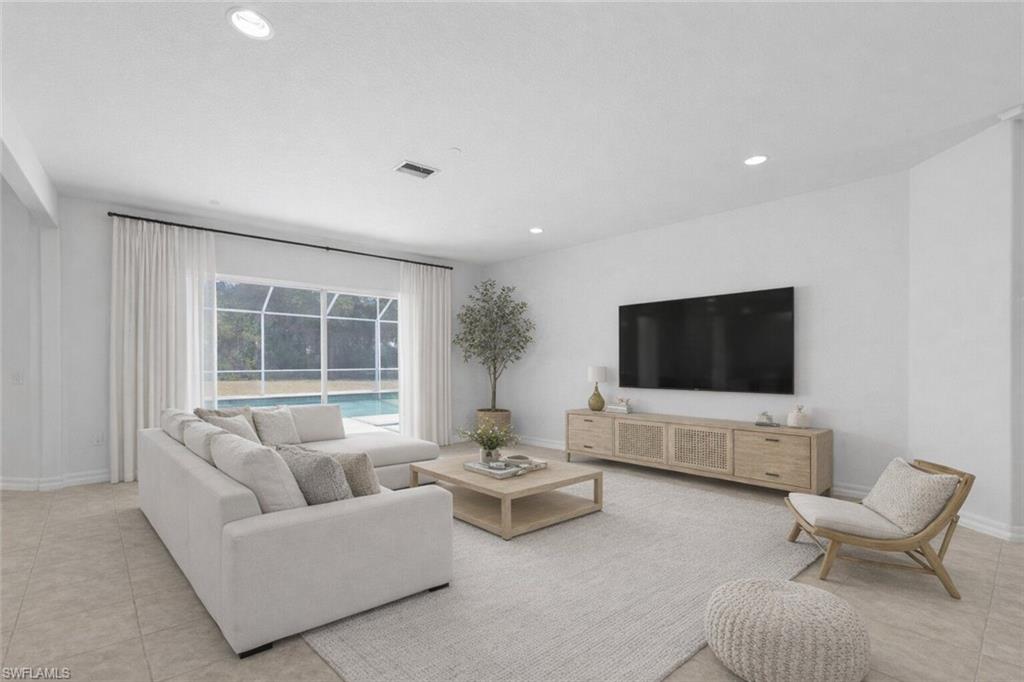 9623 Springlake Circle Estero, FL 33928 - Photo 9 of 47 a living room with furniture and a flat screen tv