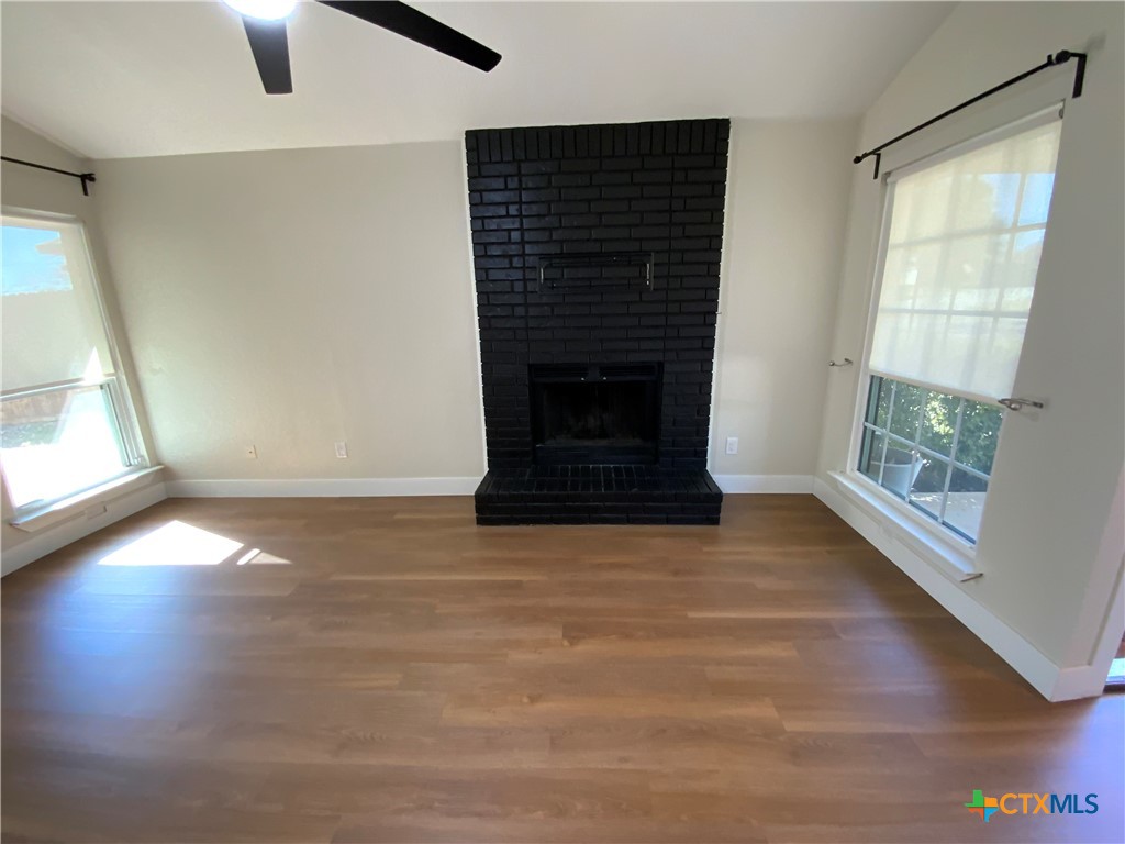 4725 Hartrick Bluff Road Temple, TX 76502 - Photo 4 of 27 an empty room with windows and fireplace