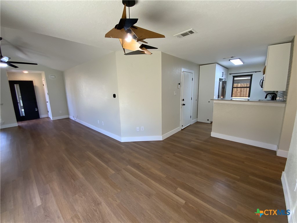 4725 Hartrick Bluff Road Temple, TX 76502 - Photo 7 of 27 a view of a room with wooden floor and a ceiling fan