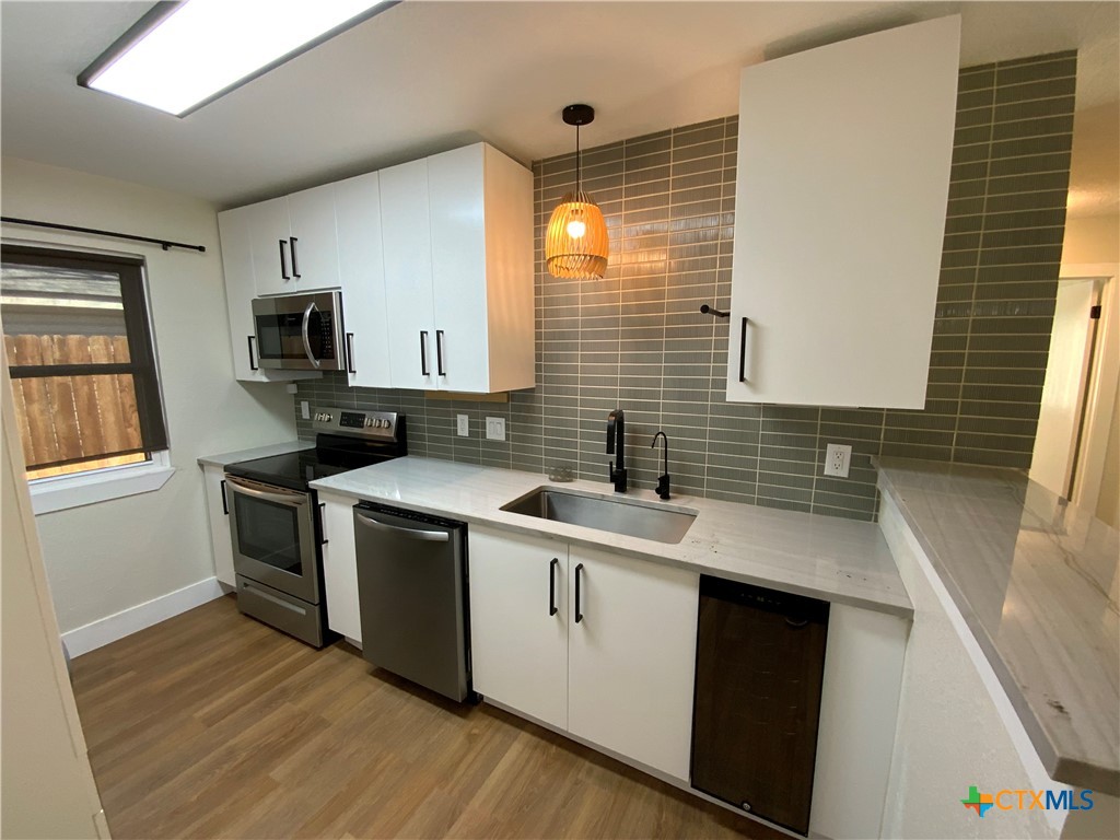 4725 Hartrick Bluff Road Temple, TX 76502 - Photo 8 of 27 a kitchen with a sink stove and cabinets