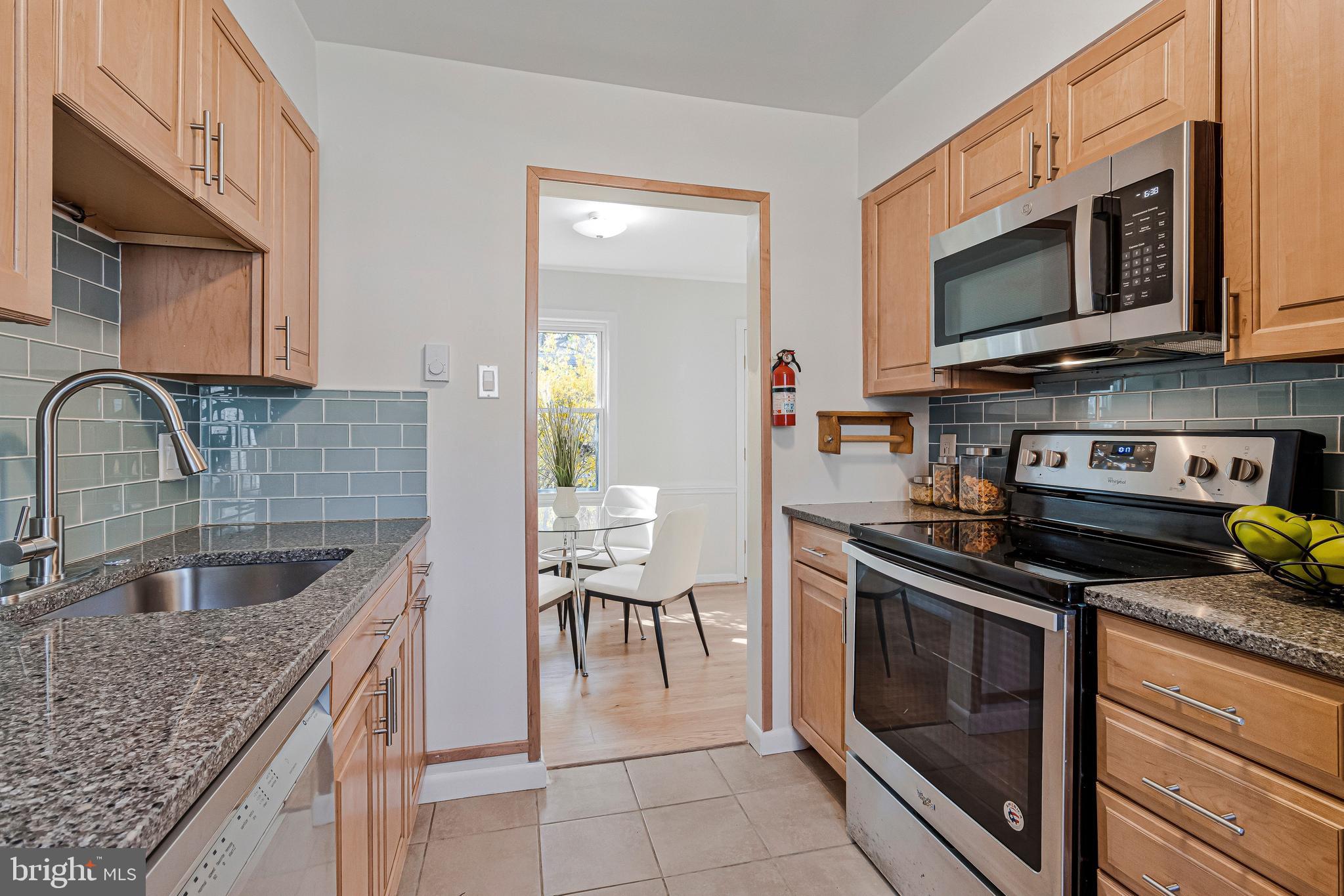 36 Ridge Road Greenbelt, MD 20770 - Photo 16 of 39 a kitchen with stainless steel appliances granite countertop a sink and a stove