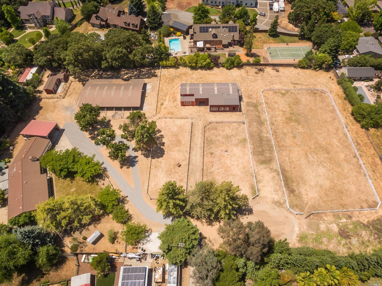an aerial view of residential houses with outdoor space