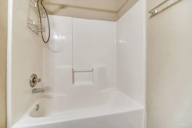 a bathroom with a bath tub with a shower