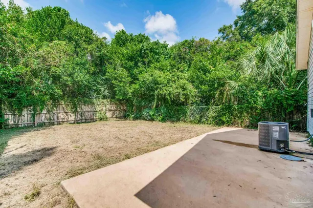 a backyard of a house with lots of green space