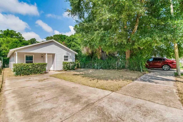 a front view of a house with a garden