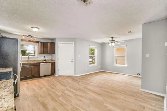 a kitchen with a refrigerator and windows
