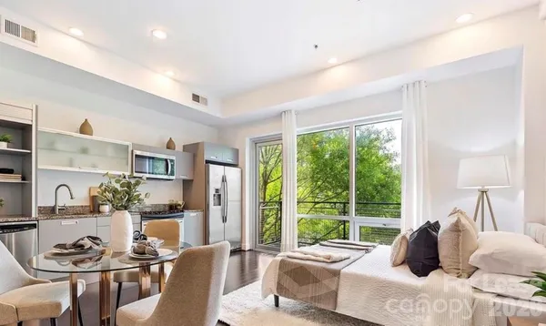 a living room with furniture and a large window