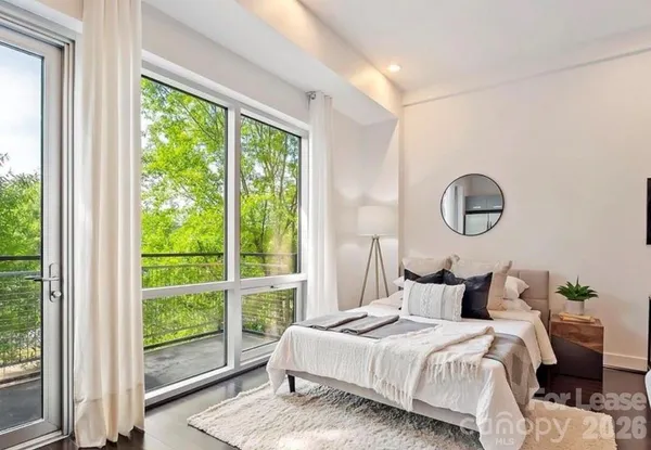 a bedroom with a bed and a window