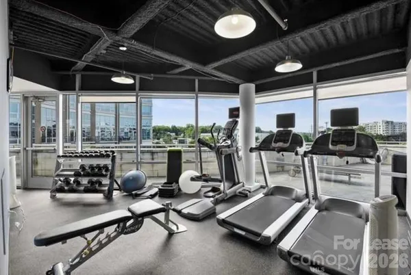 a room with gym equipment and glass door