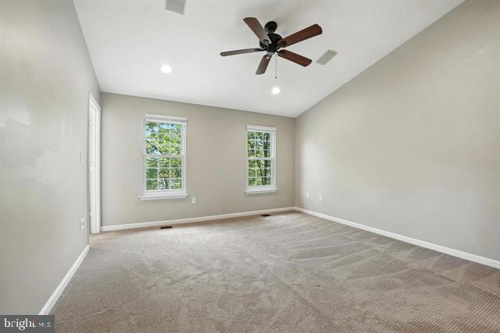1547 Northern Neck Drive, Unit 201 Vienna, VA 22182 - Photo 17 of 23 an empty room with a ceiling fan and windows