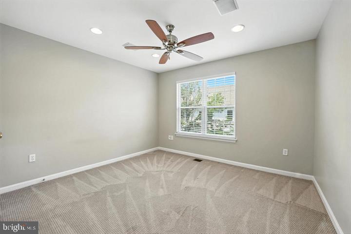 1547 Northern Neck Drive, Unit 201 Vienna, VA 22182 - Photo 19 of 23 an empty room with window and ceiling fan