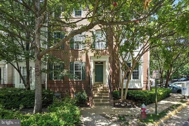 a view of a house with a tree in front