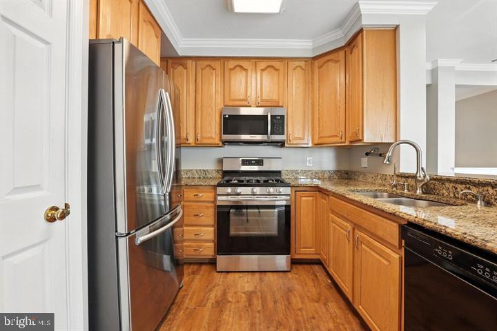 1547 Northern Neck Drive, Unit 201 Vienna, VA 22182 - Photo 3 of 23 a kitchen with a refrigerator stove and sink