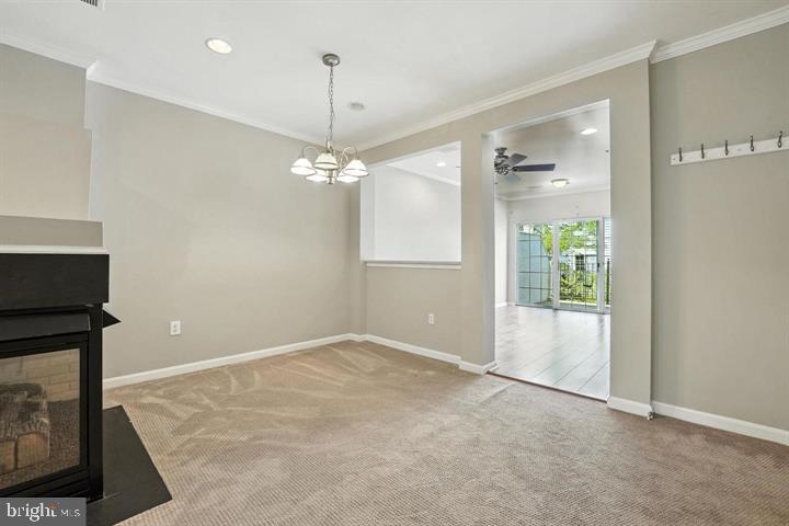 1547 Northern Neck Drive, Unit 201 Vienna, VA 22182 - Photo 4 of 23 an empty room with chandelier fan and windows