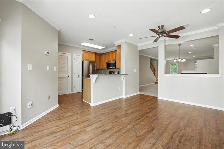 1547 Northern Neck Drive, Unit 201 Vienna, VA 22182 - Photo 8 of 23 a view of a kitchen with wooden floor and a refrigerator