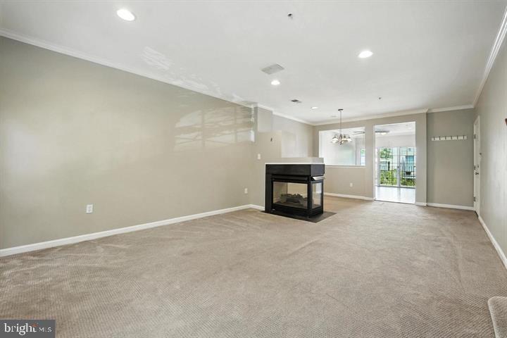1547 Northern Neck Drive, Unit 201 Vienna, VA 22182 - Photo 10 of 23 an empty room with fireplace and window