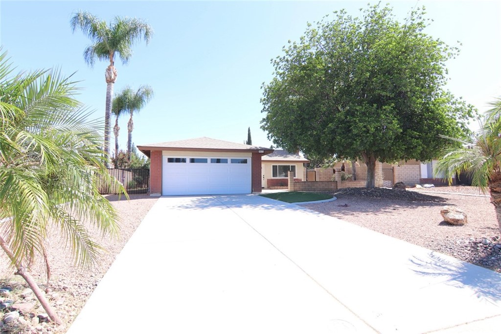 3075 Strasbourg Drive Riverside, CA 92504 - Photo 1 of 1 a front view of a house with a yard and garage
