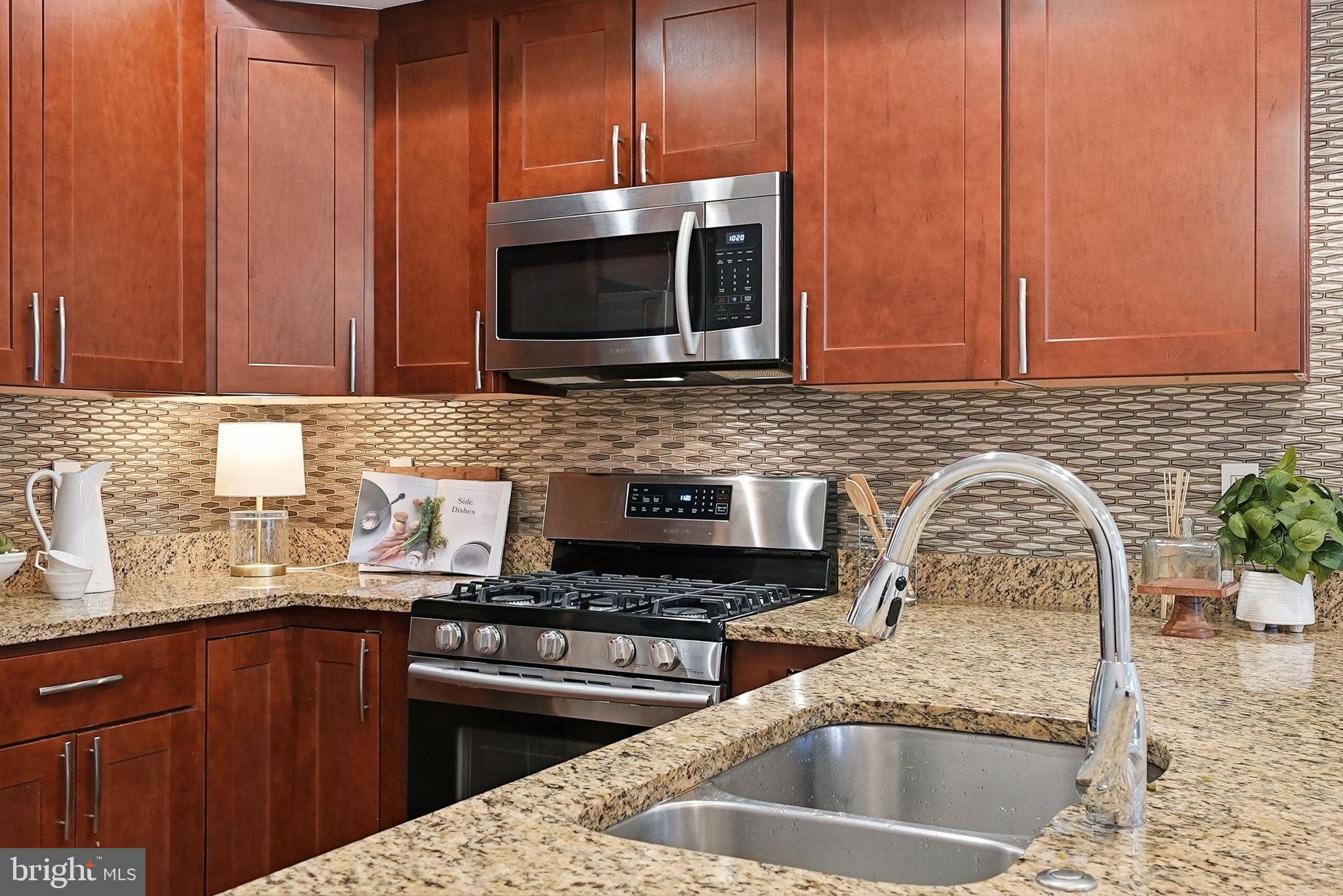 1512 F Street Northeast, Unit 2 Washington, DC 20002 - Photo 13 of 37 Modern kitchen with rich wood cabinetry.
