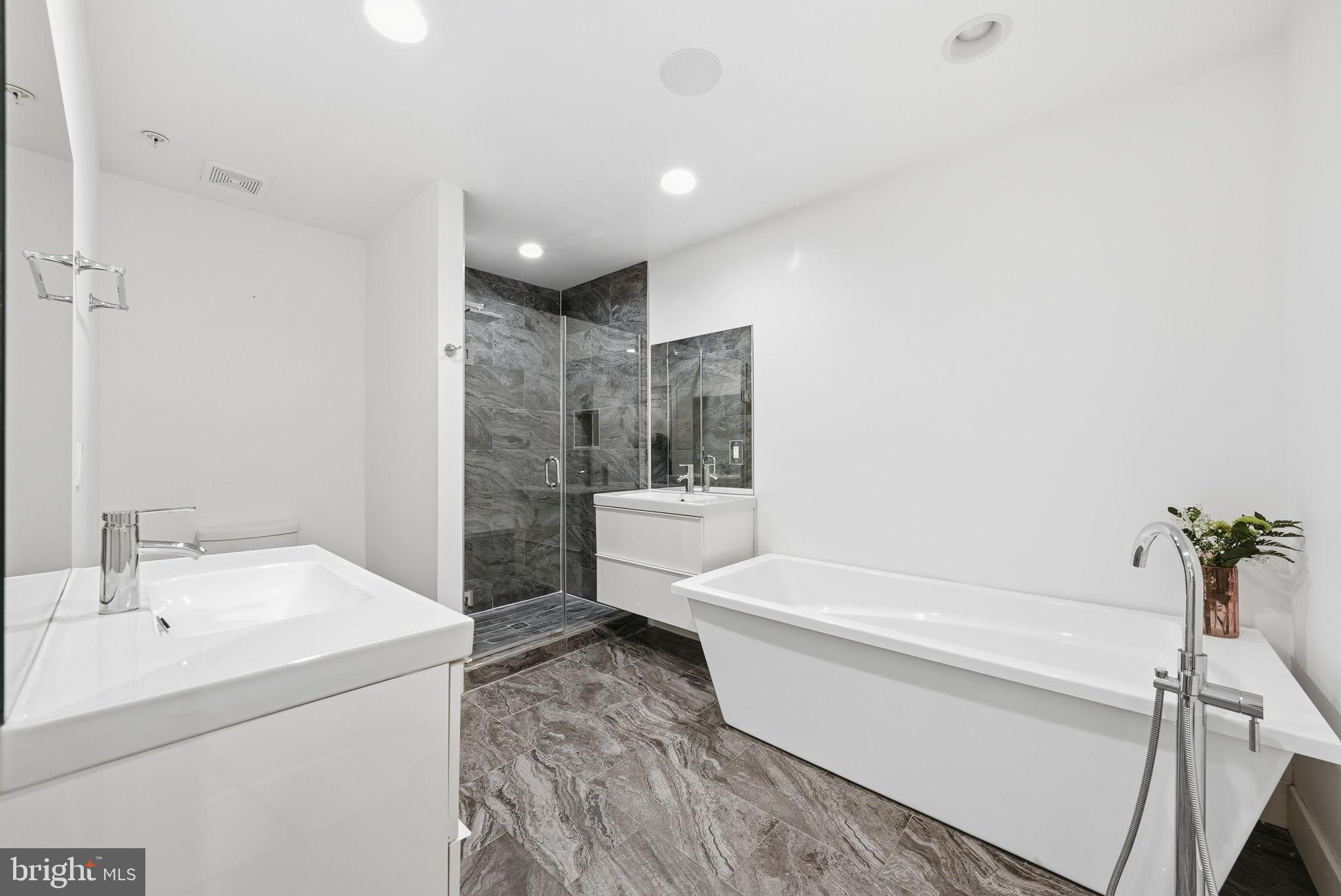 1512 F Street Northeast, Unit 2 Washington, DC 20002 - Photo 23 of 37 Sleek modern bathroom with elegant finishes.
