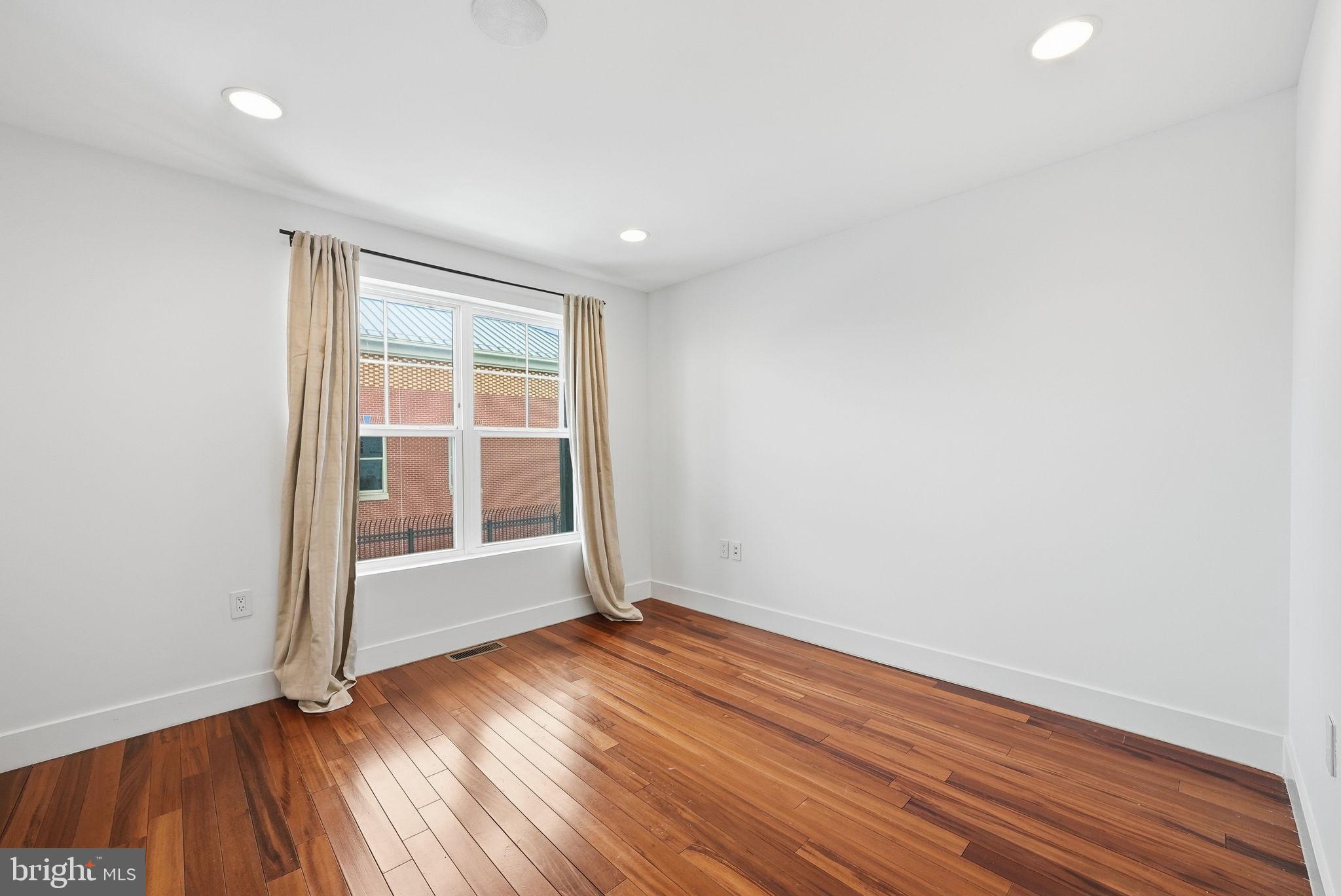 1512 F Street Northeast, Unit 2 Washington, DC 20002 - Photo 26 of 37 Bright and airy room with warm wood floors.