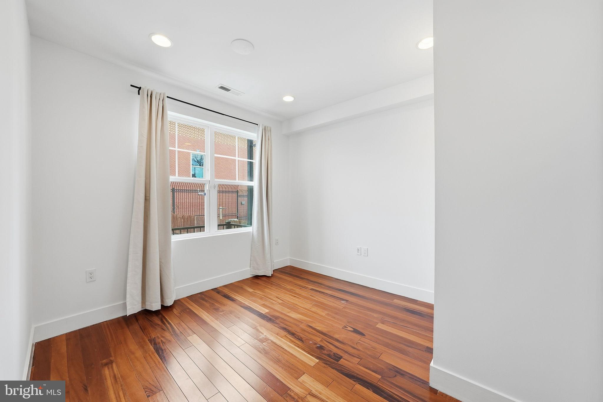 1512 F Street Northeast, Unit 2 Washington, DC 20002 - Photo 31 of 37 Bright and airy room with warm wood floors.