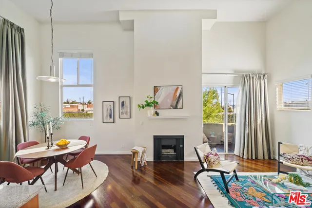 a living room with furniture a fireplace and a table