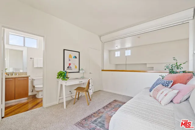 a bedroom with a bed and a table