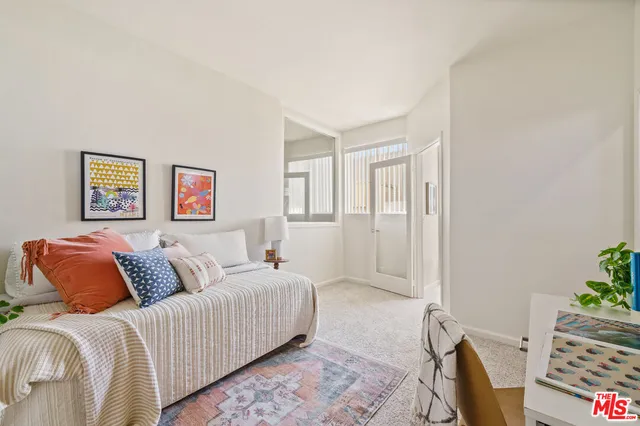 a bedroom with a bed and a couch