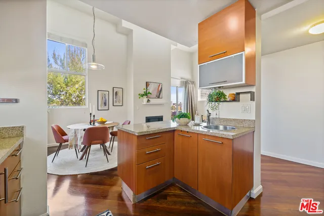 a living room with granite countertop furniture a fireplace and a flat screen tv