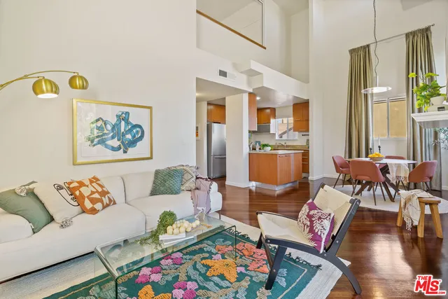 a living room with furniture and a floor to ceiling window