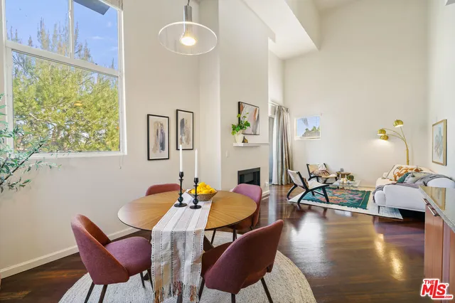 a dining room with furniture and wooden floor