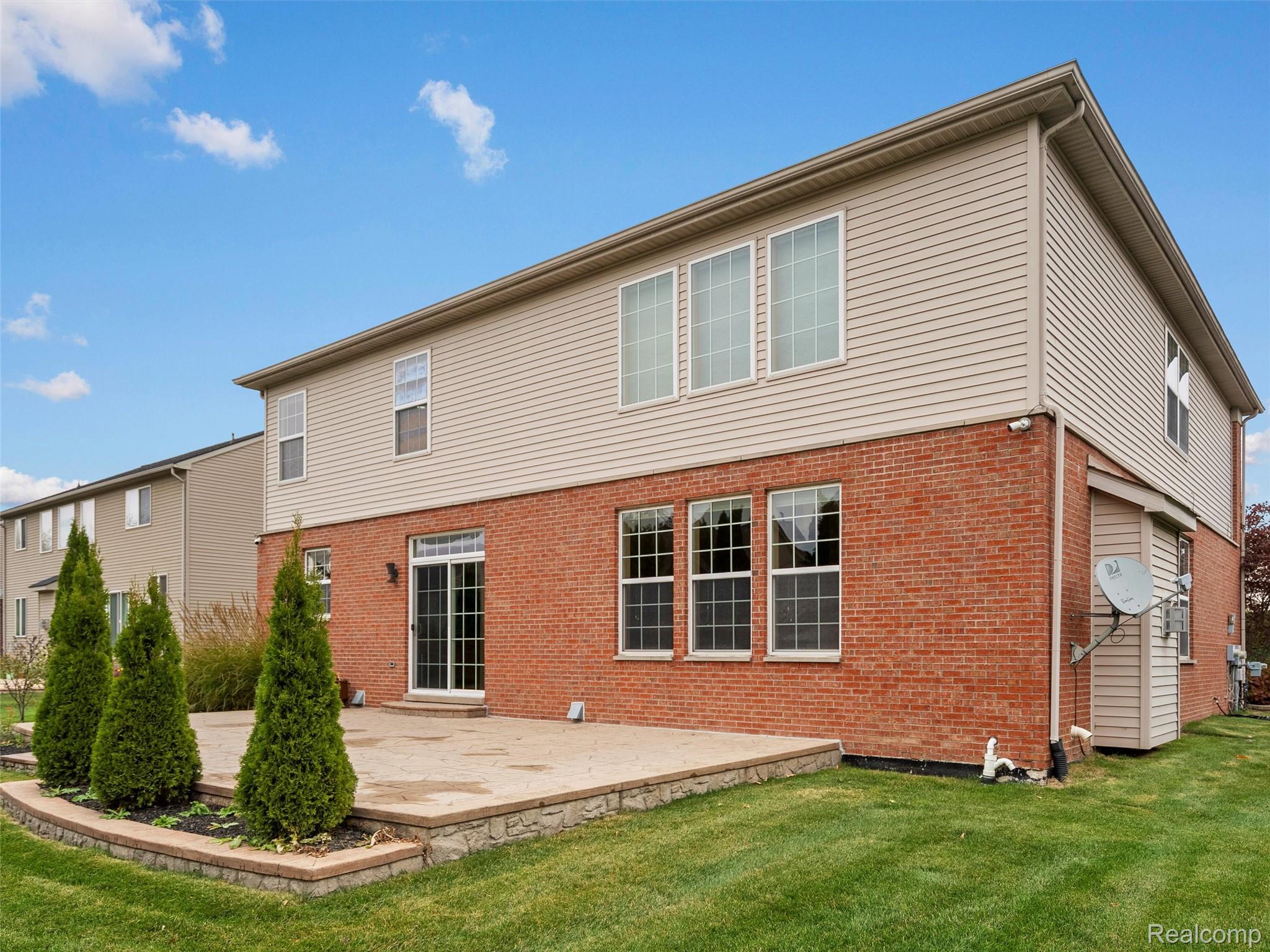 3191 Wren Lane Rochester, MI 48309 - Photo 60 of 63 Back of house featuring brick siding and a lawn