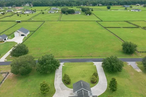 an aerial view of a house with a swimming pool